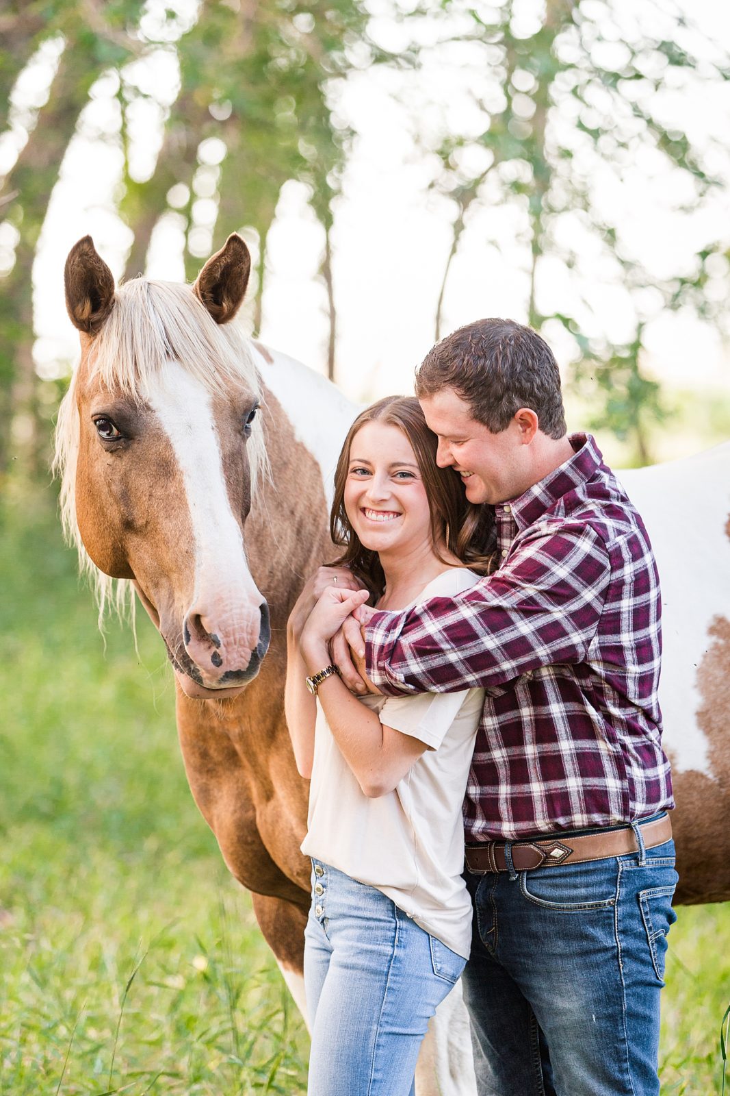 Engaged couple with horse
