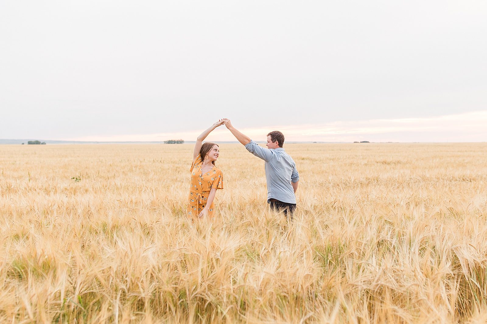 Engaged couple in a wheat field