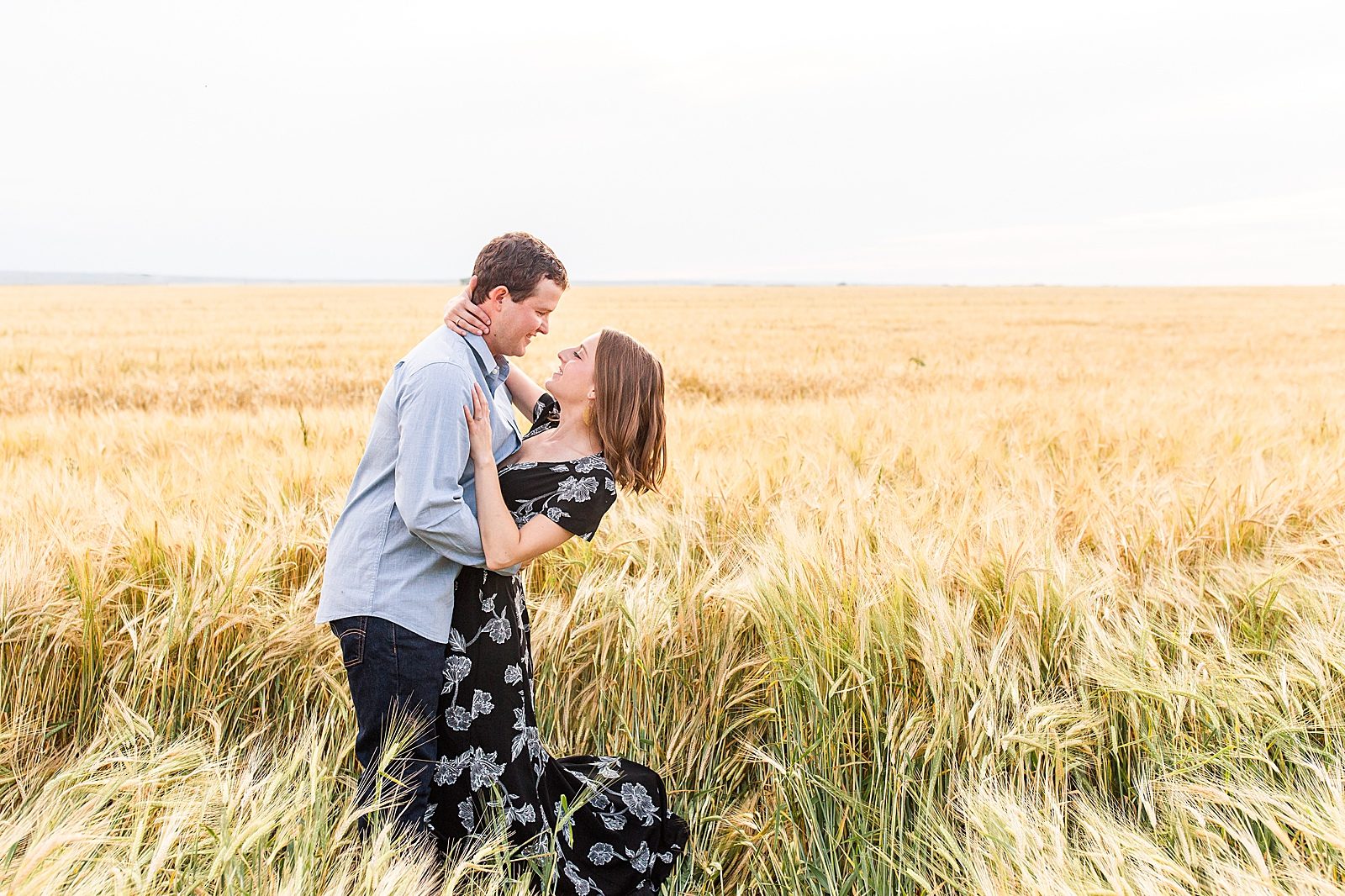 Engaged couple in a wheat field