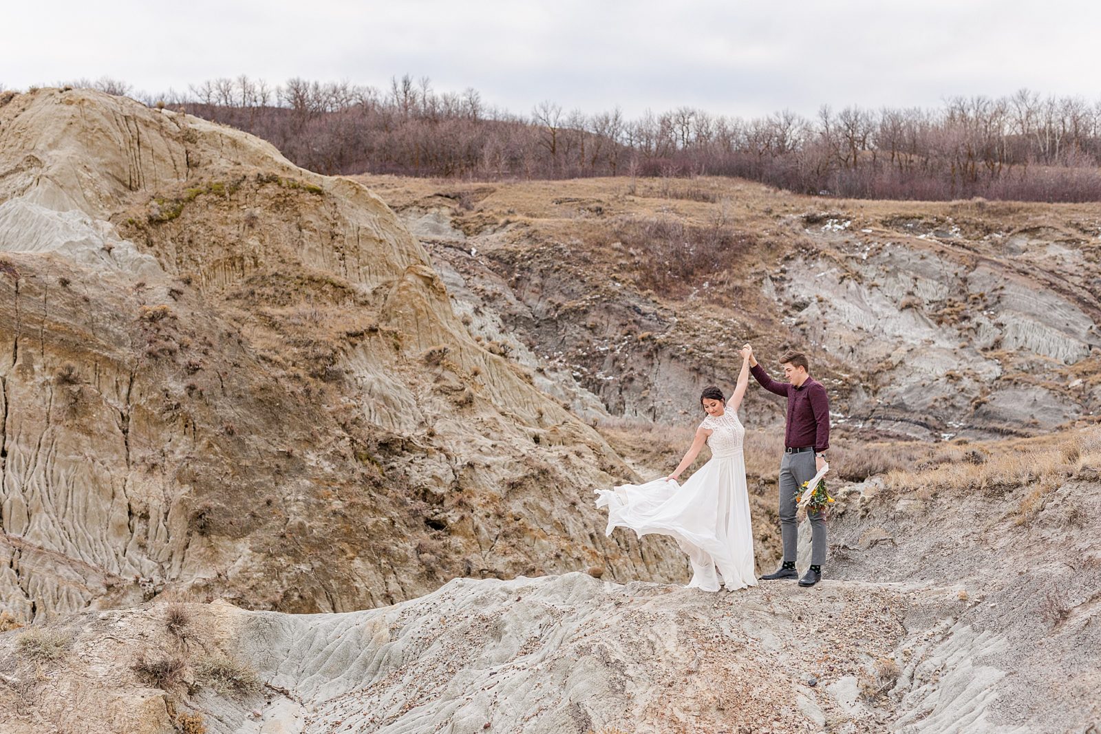 Bride and groom eloping in Saskatchewan at Claybanks Brick Mine bad lands