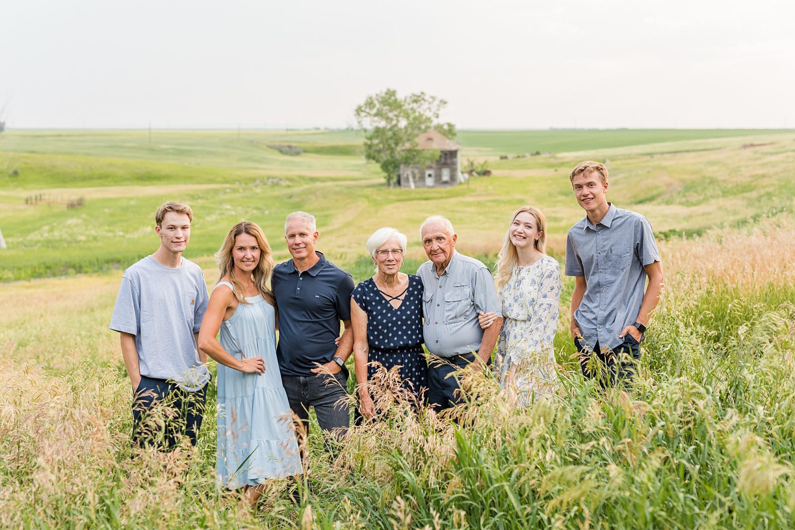 Family standing in a field with their grandparents