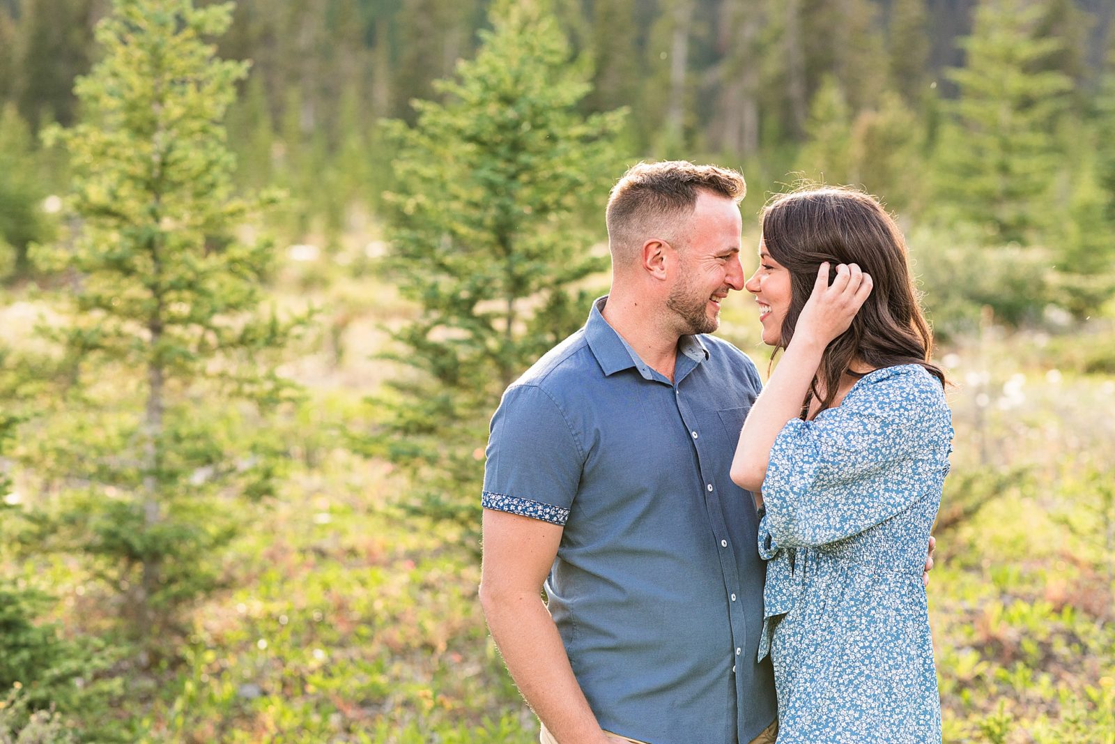 Couple looking at each other in front of mountains in Kananaskis 