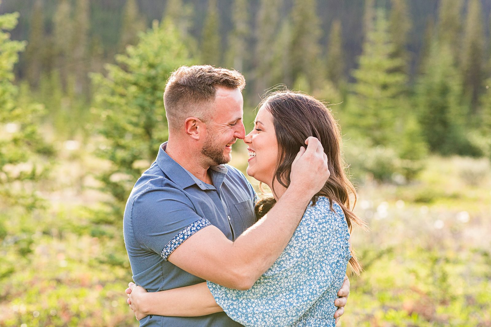 Couple laughing in front of mountains in Kananaskis 
