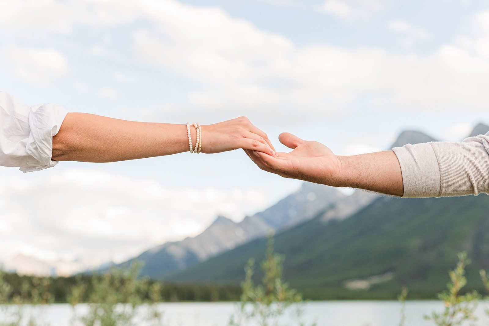 Couple holding hands in the mountains in Kananaskis 