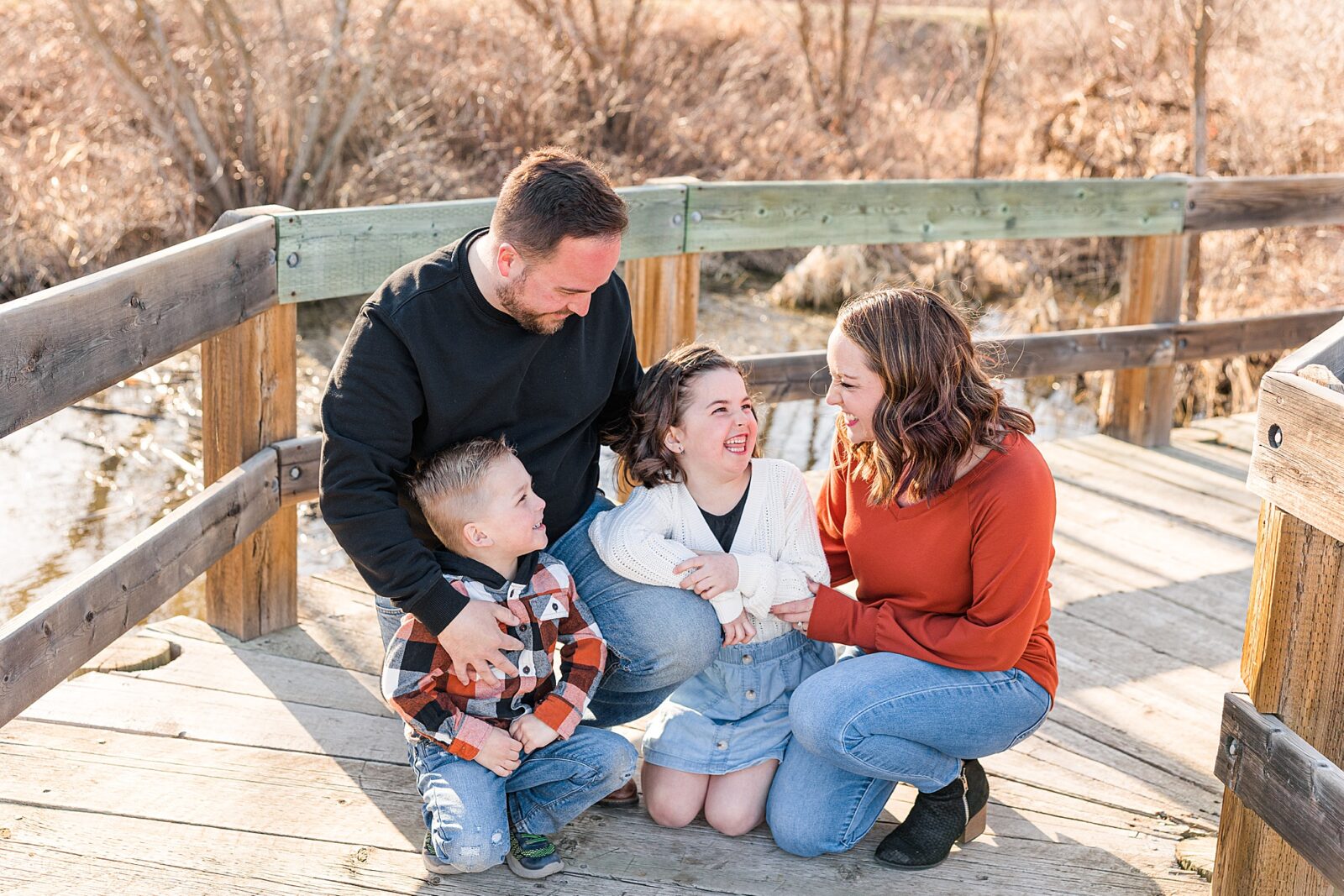 Moose Jaw Spring Family session on boardwalk family laughing